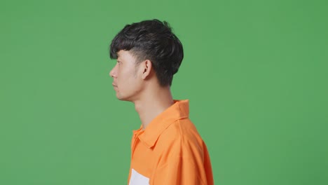 man in orange shirt profile view