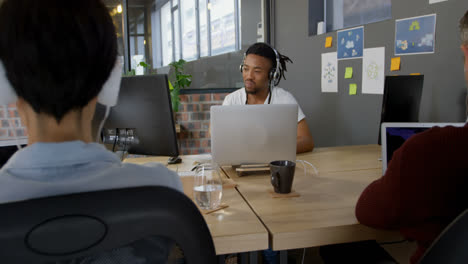 Attentive-male-executive-using-laptop-in-office-4k