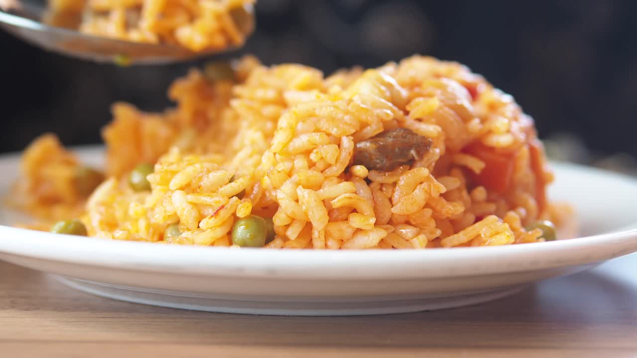 A plate of spanish rice with peas | Premium Stock Video Footage