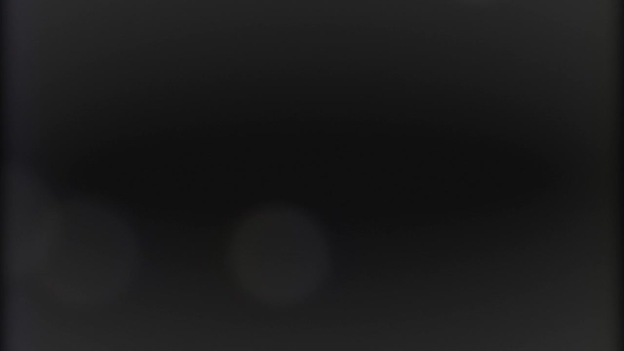 Abstract Dark Background with Subtle Light Leaks and Bokeh