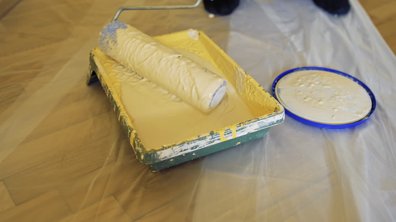 Painting wall with roller brush. Apartment redecoration and home construction while renovating and improving