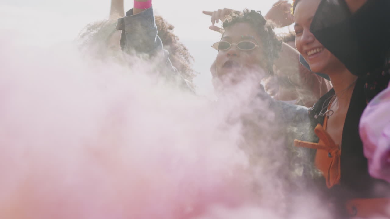 Group Of Young Friends Dancing Behind Barrier At Outdoor Music Festival