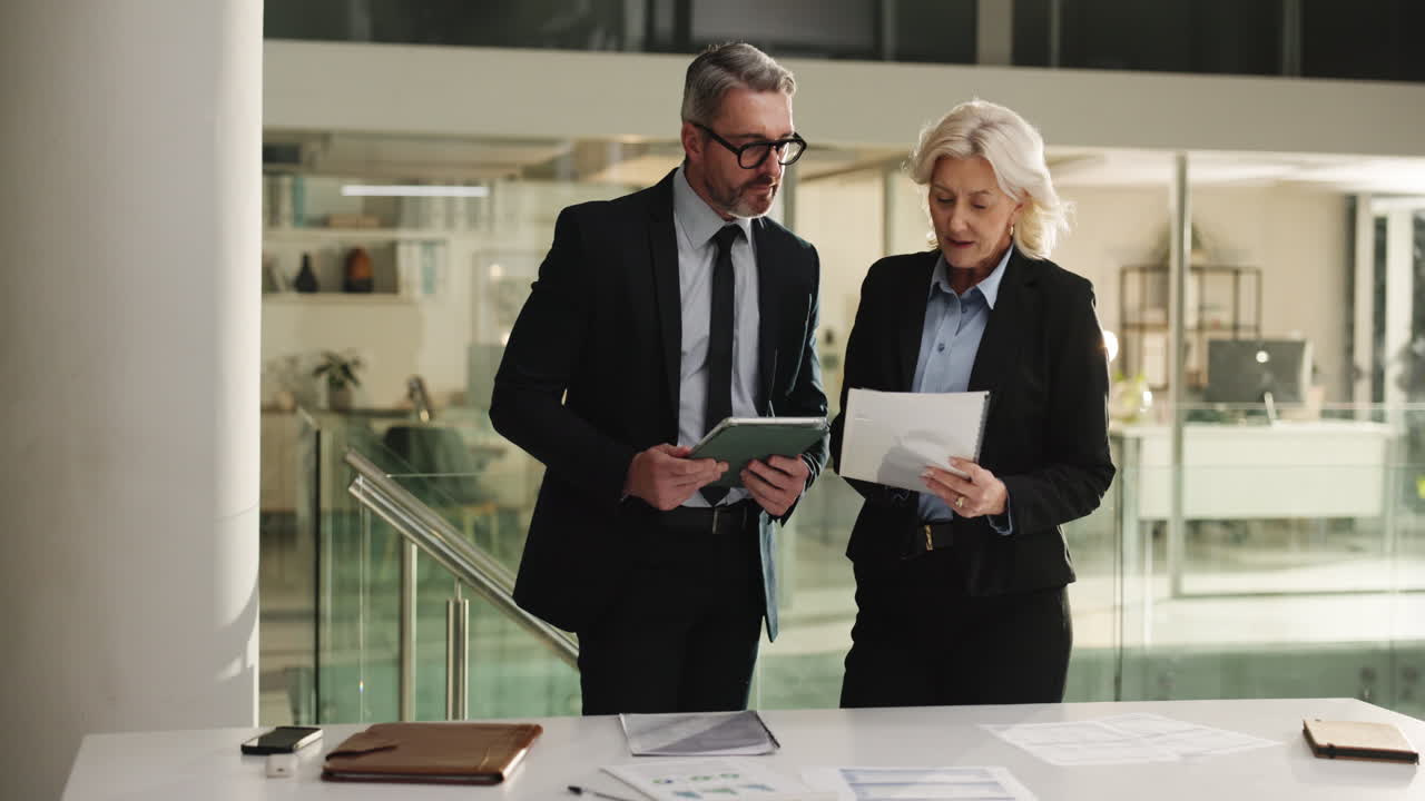 Business professionals discussing work in a modern office