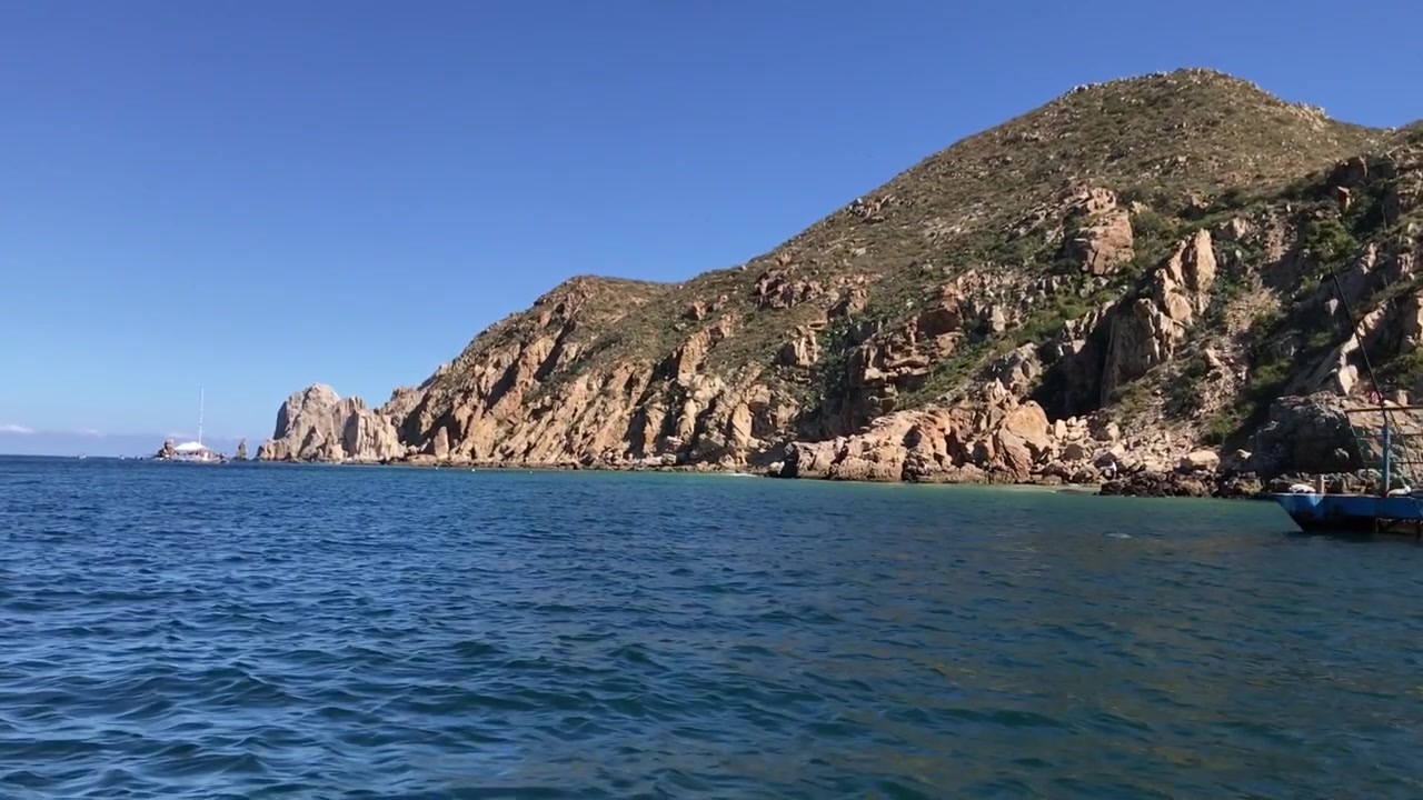 Navigando velocemente verso un'isola montuosa e rocciosa con acque splendide.