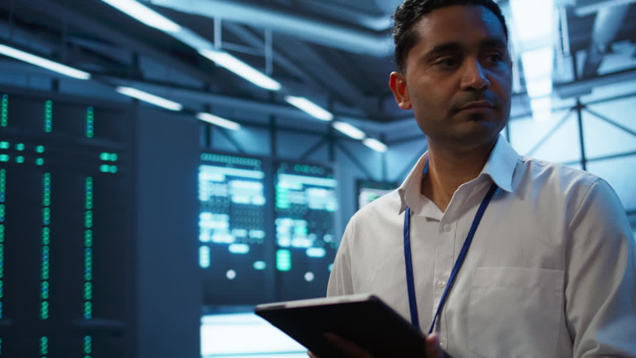 IT professionals updating server room systems using tablet