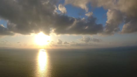 time lapse of the suns golden rays reflecting off the ocean during sunset with dramatic clouds passing by, pattaya, thailand