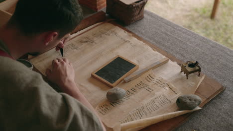 historian writing on a manuscript