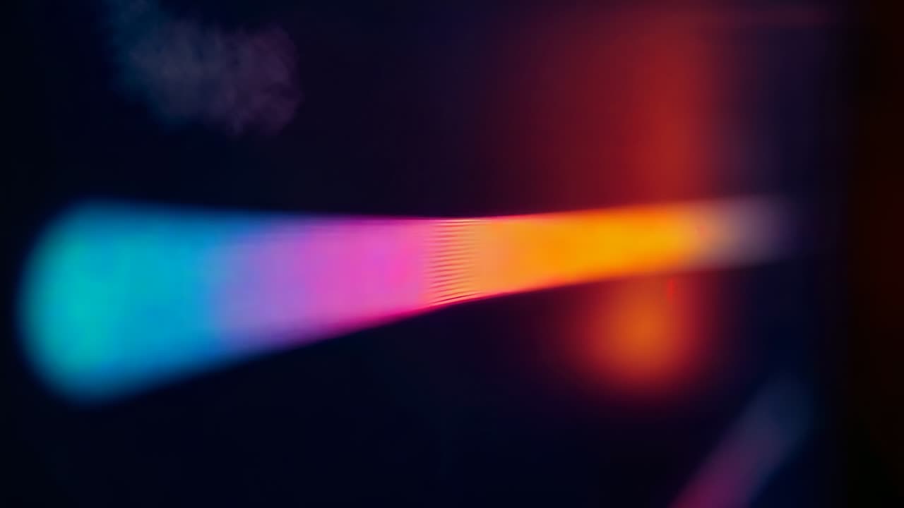 Looping gradient bar shifting amber yellow teal pink on screen with red blur as pulsing equalizer