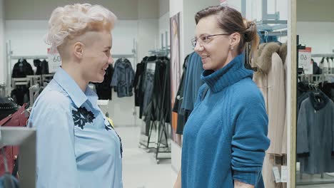 two women shopping for clothes in a clothing store