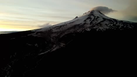 us, oregon, mt hood, , 2025-05-10 - drone view of mt hood in northern oregon at sunset with clouds curling over the peak of the mountain in the spring.