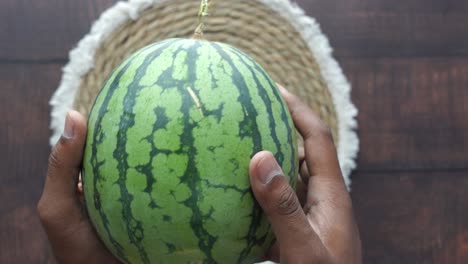 hands holding a watermelon