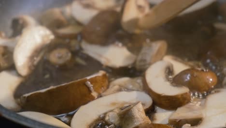 close up of fresh sliced mushrooms cooking in a pan for a delicious healthy recipe