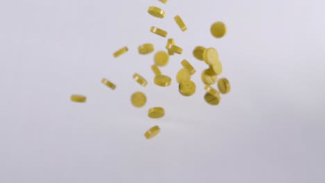 slow motion shot of yellow curcumin medical pills flying in air, phenolic compound