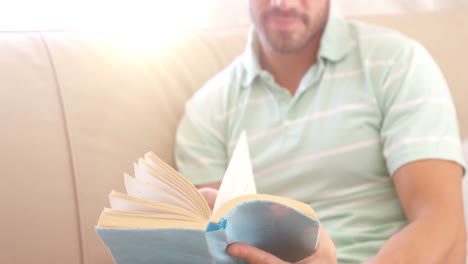 Men-reading-book-on-a-sofa