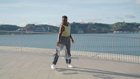 flexible performer dancing chair embankment vertical video. dancer choreography