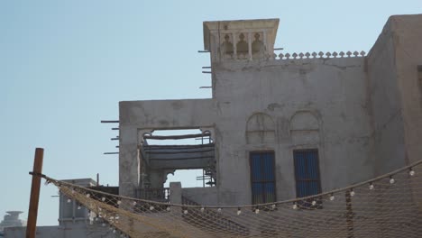 Restored-Traditional-Houses-In-Al-Fahidi-Historical-Neighbourhood-With-Wind-Catcher-Canopy-Of-Foliage-In-Dubai,-UAE