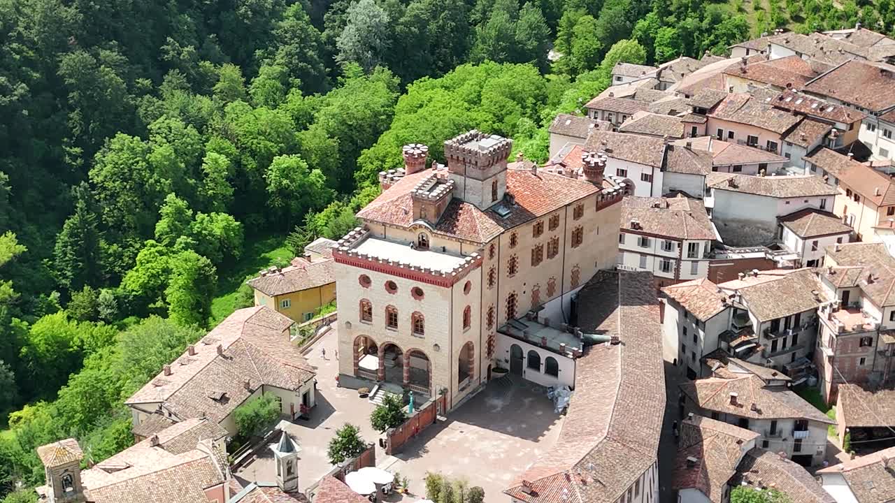 Barolo Castle in Langhe Wine Region, Cuneo, Piedmont, Italy. 4K Aerial view of the village and the vineyards, circling to the right, close view of the casle.