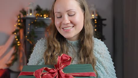 happy brunette getting big wrapped christmas gift, pov view