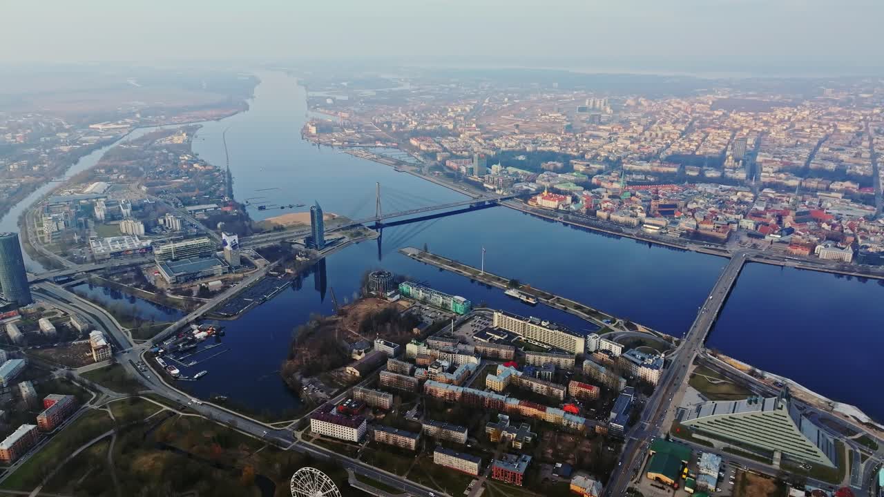 Bird’s-eye perspective of urban Riga unfolding alongside vast blue Daugava River