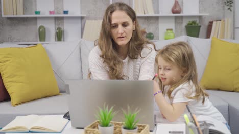 businesswoman works in her home office and takes care of her little daughter.