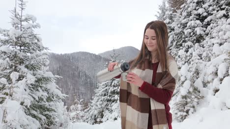 young pretty girl drinks hot tea on the date in winter forest young pretty girl drinks hot tea on the date in winter forest