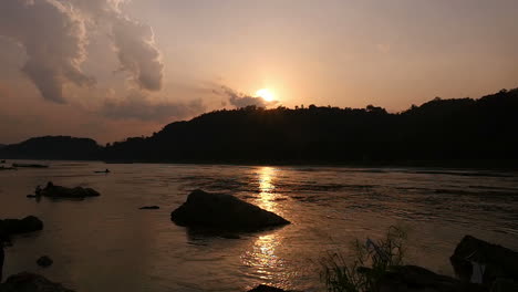 sunset over the river with boats