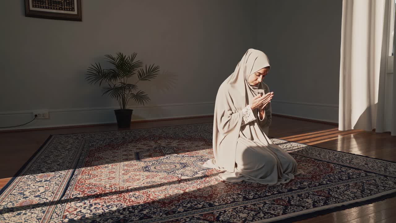 A serene video scene of a woman in prayer, captured from a side angle