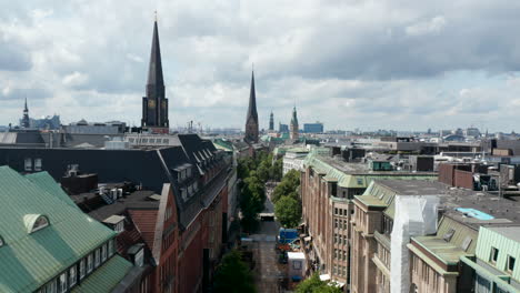 Descending-shot-of-historic-city-centre-with-known-landmarks,-churches-and-old-buildings.-Free-and-Hanseatic-City-of-Hamburg,-Germany