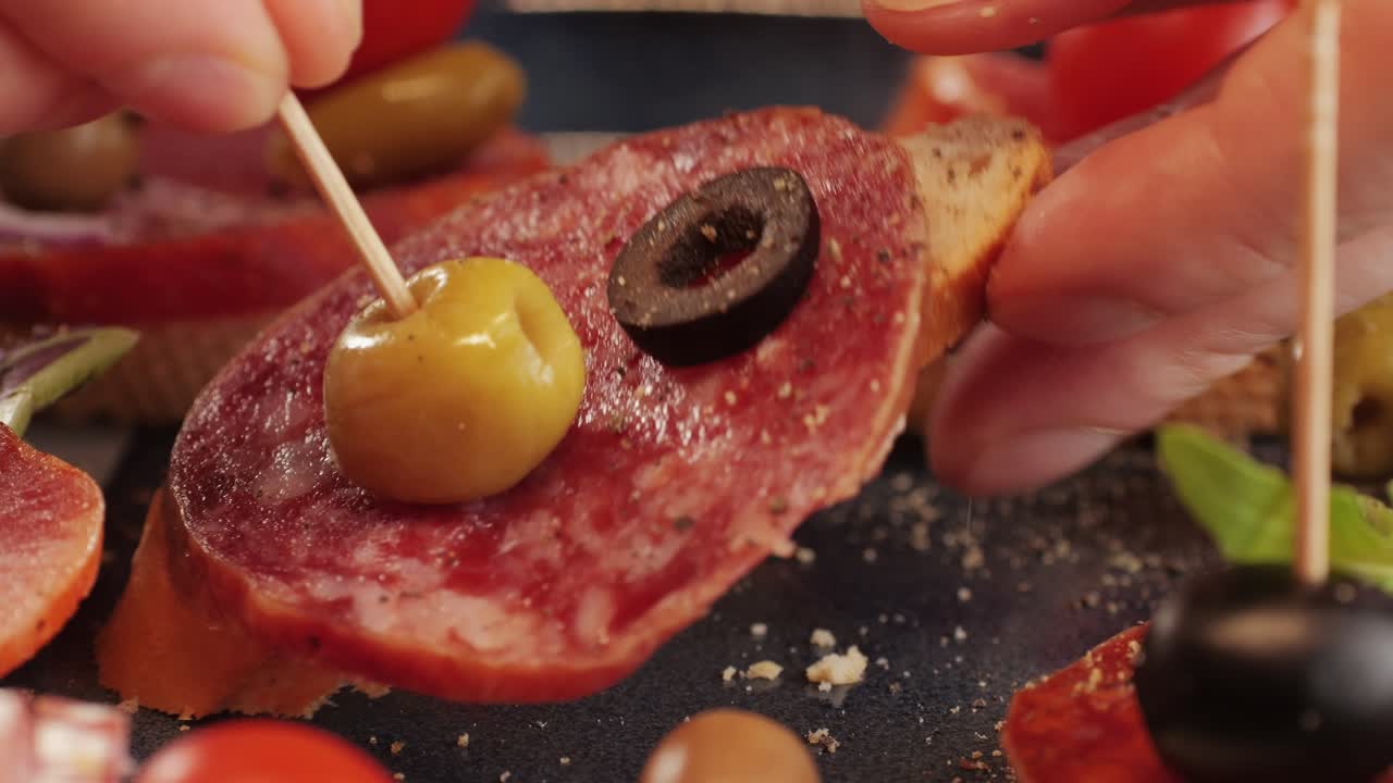 Mix of spanish pork sausages, Cutting board of appetizing catalonian snack - fuet, jamon, chorizo, olives, supermarket tapas food in spain, traditional cuisine.