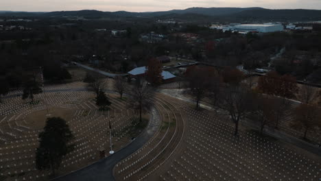 cemetery graveyard white tombstones in a circle around american flag pole