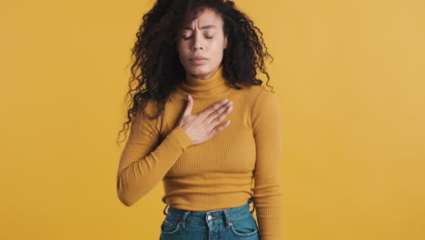 una mujer afroamericana sobre un fondo naranja.