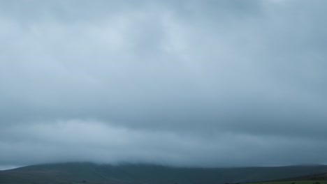 Dark-grey-layered-storm-clouds-over-mountains