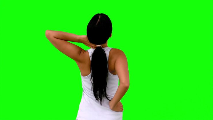 Woman in sportswear stretching her back on green screen