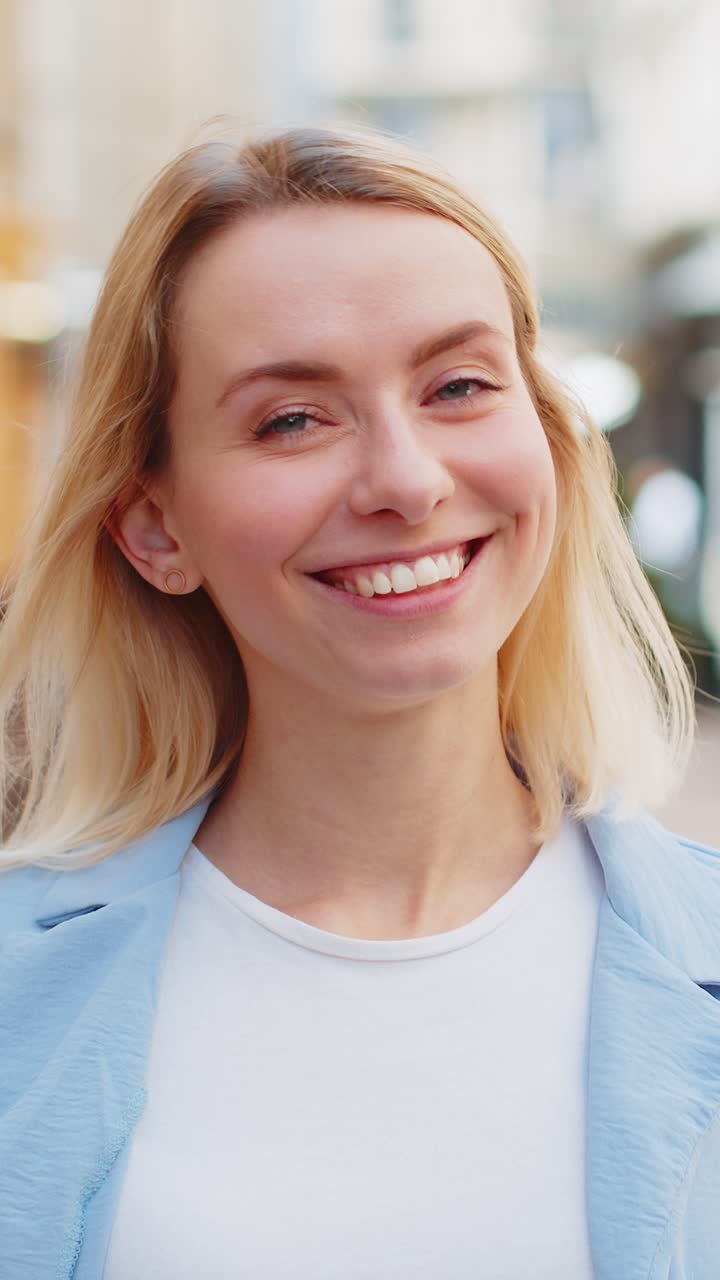 feliz mujer rubia sonriendo mirando lejos soñando descansando buenas noticias sentirse satisfecho en la calle de la ciudad