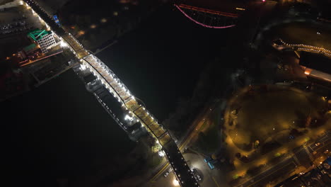 aerial view tilting over the illuminated bridges of nashville, night in usa