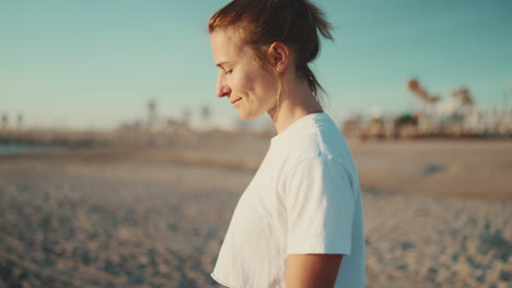 sporty girl walking by the sea after workout.