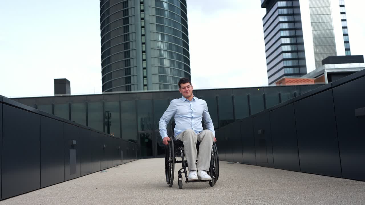 Young Man in Wheelchair Smiling in Modern Urban Environment