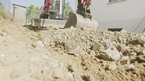 Wideangle-medium-shot-of-a-mini-excavator-parked-on-a-private-driveway