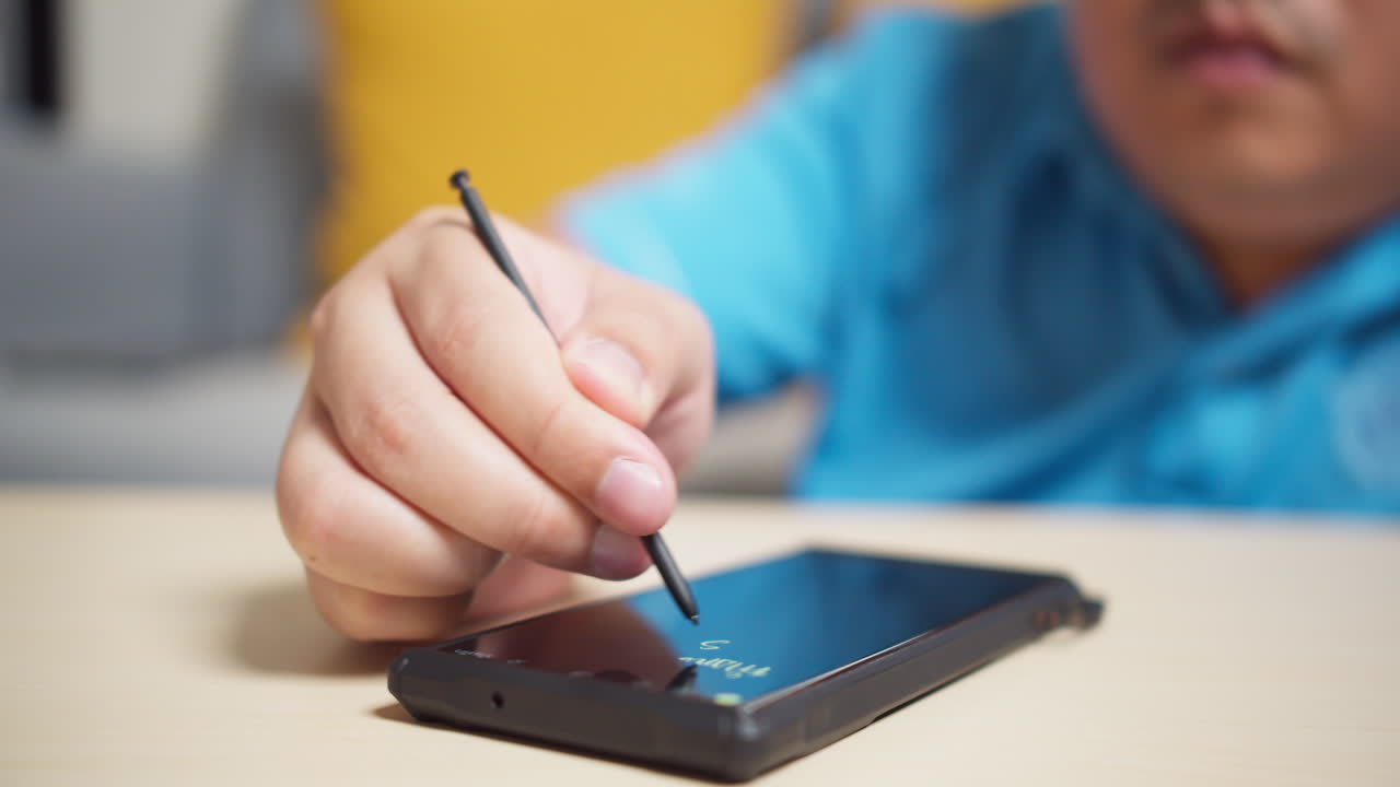 Men use stylus pen technology on a smartphone to write and work with digital applications
