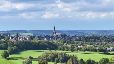 beautiful summer’s day, picturesque village dominated by tall church spire