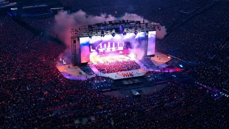 stunning aerial view of a vibrant concert, showcasing dazzling lights and a huge, energetic crowd enjoying the electrifying atmosphere in a packed stadium