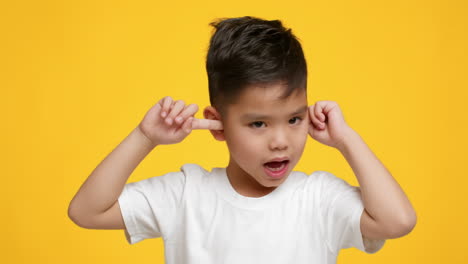 Boy covering his ears