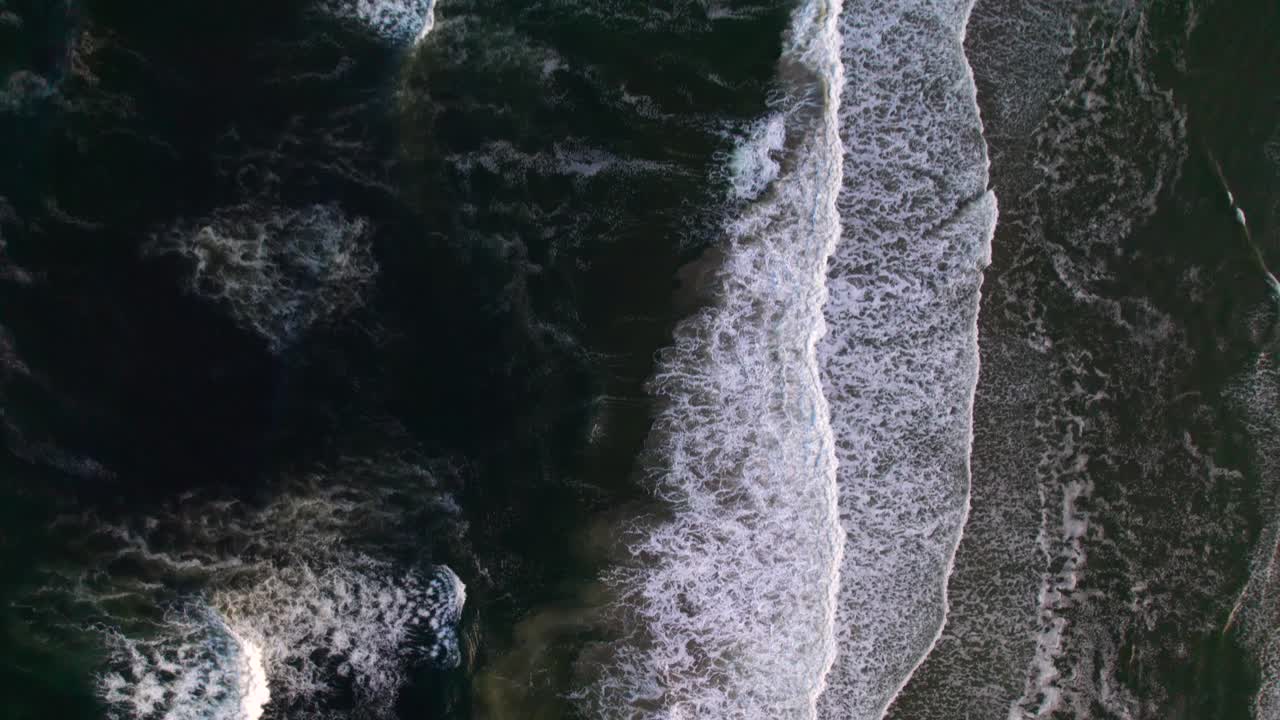 Overhead aerial of breaking waves soothing and peaceful