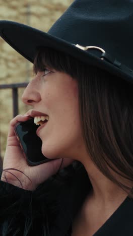 elegant dressed woman on the town bench having a fun call close up