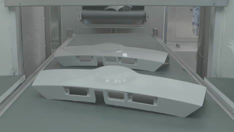 the automated process polishes the painted surface of a car with a pneumatic polishing machine. waxing car in production line factory plant