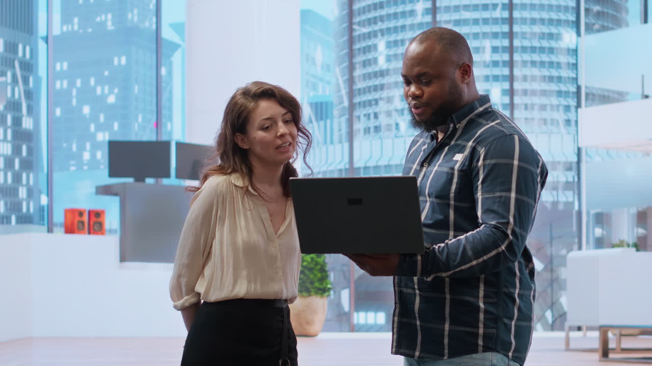 Realtor broker showing architectural blueprints on laptop to business team