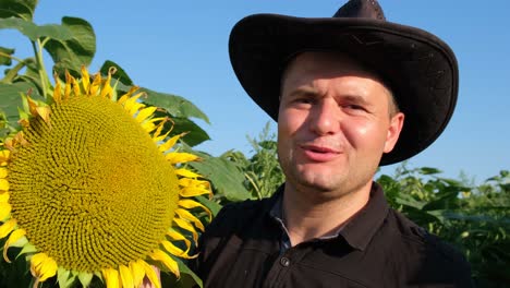 A Young Farmer in a Sunflower Field Demonstrates and Talks about the Harvest a Young Farmer in a Sunflower Field Demonstrates and Talks about the Harvest Cultivation of Sunflower for Oil Production