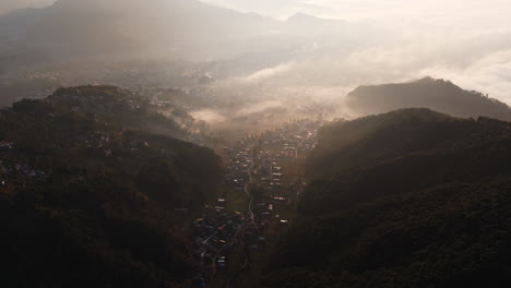 aerial tracking shot overlooking the misty archalbot suburbs in pokhara, nepal