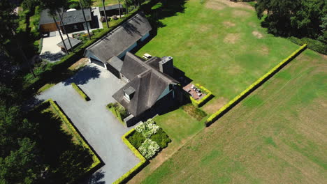 aerial view of a house with straw roof and garden