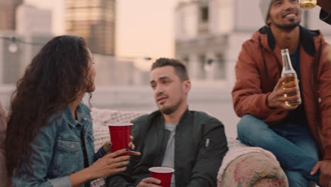 happy multi ethnic friends enjoying weekend rooftop party drinking alcohol taking selfie photos using smartphone sharing on social media